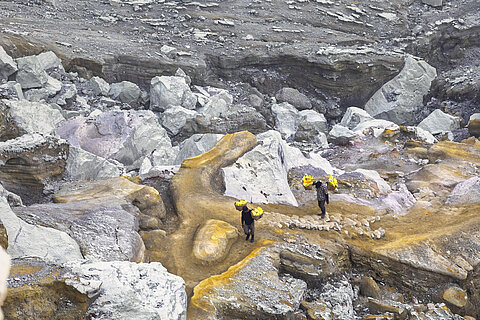 The picture shows sulfur miners working at Kawah Ijen Volcano in Indonesia. 